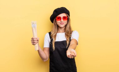 artist painter smiling happily with friendly and  offering and showing a concept