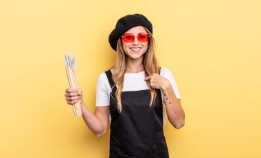 artist painter feeling happy and pointing to self with an excited