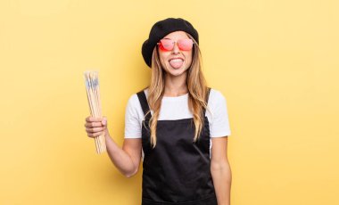 artist painter with cheerful and rebellious attitude, joking and sticking tongue out