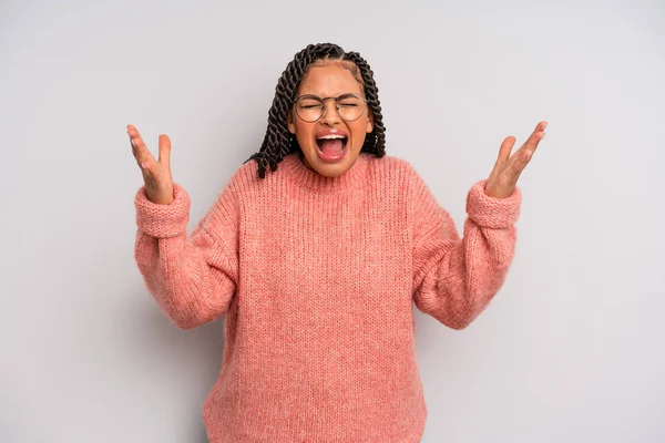 Siyah afro kadın öfkeyle bağırıyor, strese giriyor ve ellerini havaya kaldırıp 