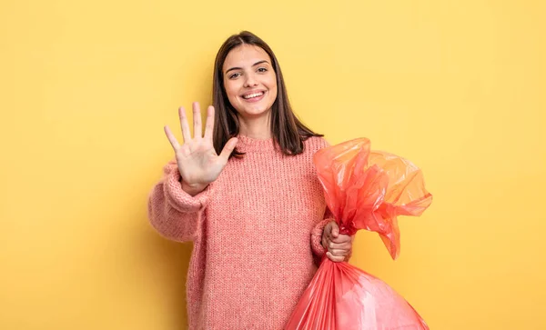 Pretty Woman Smiling Looking Friendly Showing Number Five Trash Bag — Fotografia de Stock