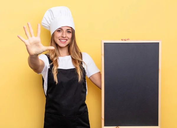 Chef Woman Smiling Looking Friendly Showing Number Five Blackboard Menu — Stockfoto