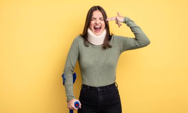 pretty woman looking unhappy and stressed, suicide gesture making gun sign. accident injured concept