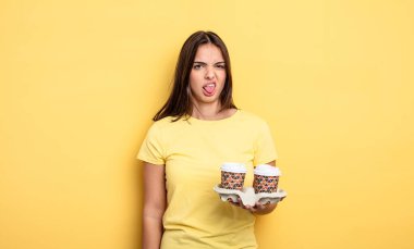 pretty woman feeling disgusted and irritated and tongue out. take away coffee concept