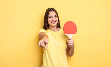 pretty woman pointing at camera choosing you. ping pong concept