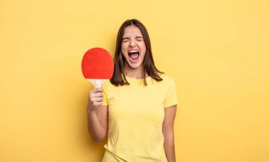 pretty woman shouting aggressively, looking very angry. ping pong concept
