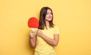 pretty woman feeling happy and facing a challenge or celebrating. ping pong concept