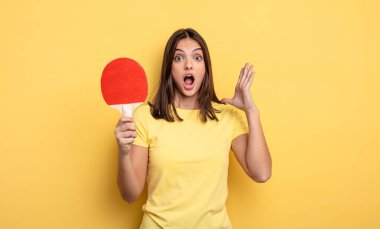 pretty woman screaming with hands up in the air. ping pong concept