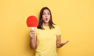 pretty woman feeling extremely shocked and surprised. ping pong concept