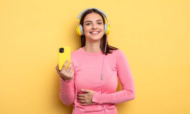 pretty woman laughing out loud at some hilarious joke. listening music concept