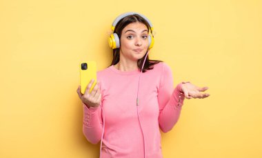 pretty woman feeling puzzled and confused and doubting. listening music concept