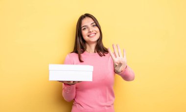 pretty woman smiling and looking friendly, showing number four. white box packaging concept