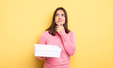 pretty woman thinking, feeling doubtful and confused. white box packaging concept