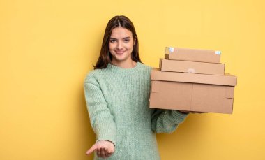 pretty woman smiling happily with friendly and  offering and showing a concept packages boxes concept