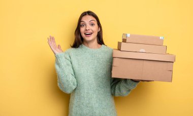 pretty woman feeling happy and astonished at something unbelievable packages boxes concept