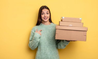 pretty woman feeling happy and pointing to self with an excited packages boxes concept