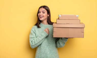 Güzel bir kadın kendini mutlu hisseder ve bir meydan okumayla yüzleşir ya da paket kutuları konseptini kutlar