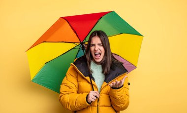pretty woman looking desperate, frustrated and stressed. winter and umbrella concept