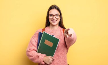 pretty student woman pointing at camera choosing you