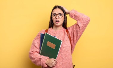 pretty student woman feeling stressed, anxious or scared, with hands on head