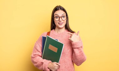 pretty student woman feeling happy and pointing to self with an excited