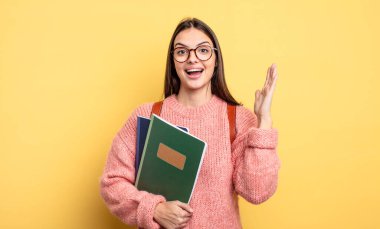 pretty student woman feeling happy and astonished at something unbelievable