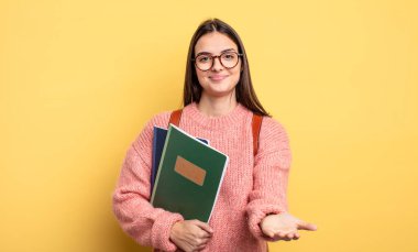 pretty student woman smiling happily with friendly and  offering and showing a concept