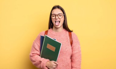 pretty student woman with cheerful and rebellious attitude, joking and sticking tongue out