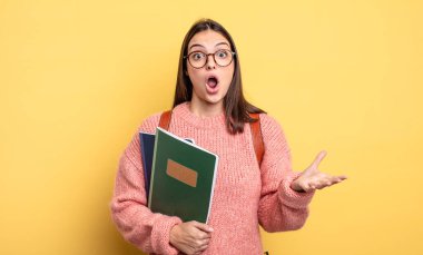 pretty student woman amazed, shocked and astonished with an unbelievable surprise