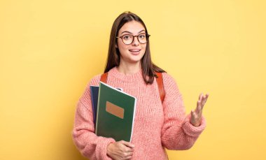 pretty student woman feeling happy, surprised realizing a solution or idea