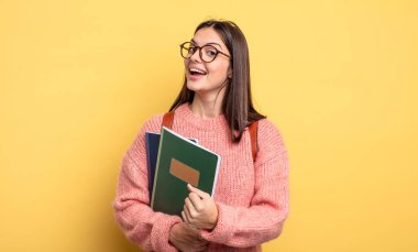 pretty student woman feeling happy and facing a challenge or celebrating