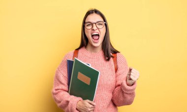 pretty student woman shouting aggressively with an angry expression