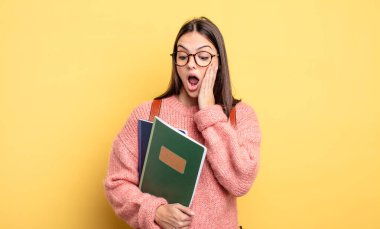 pretty student woman feeling happy, excited and surprised