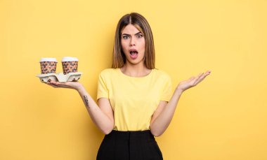 Güzel bir kadın son derece şaşırmış ve şok olmuş hissediyor. kahve konseptini kaldır.