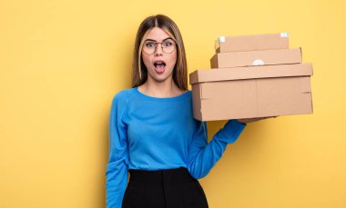 pretty woman looking very shocked or surprised packages boxes concept