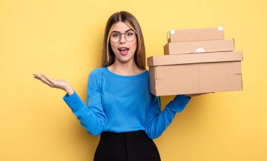 pretty woman feeling happy and astonished at something unbelievable packages boxes concept