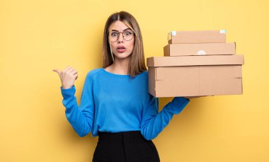 İnançsızlık paketleri konseptine hayret eden güzel bir kadın.
