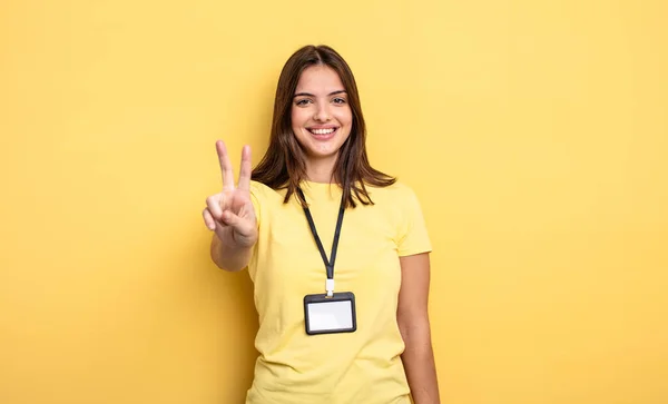 Pretty Woman Smiling Looking Friendly Showing Number Two Accreditation Card — Stockfoto