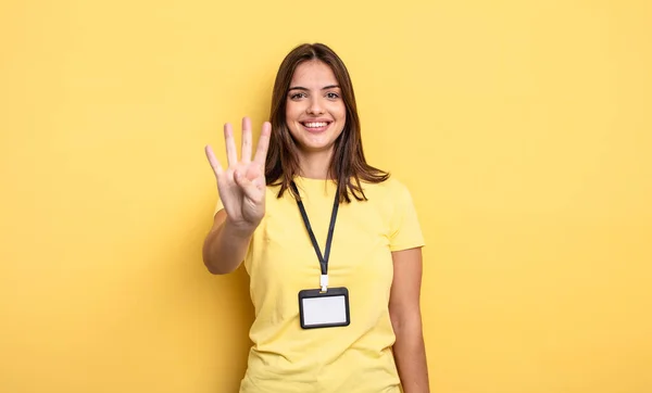 Pretty Woman Smiling Looking Friendly Showing Number Four Accreditation Card — Stockfoto