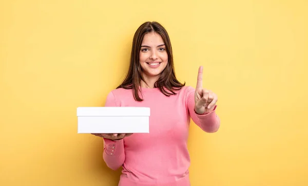 Pretty Woman Smiling Looking Friendly Showing Number One White Box — Foto de Stock