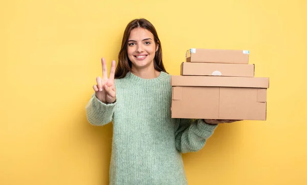 Pretty Woman Smiling Looking Happy Gesturing Victory Peace Packages Boxes — Stockfoto