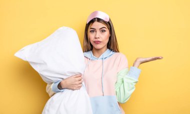 Güzel bir kadın şaşkın, şaşkın ve şüpheci hissediyor. pijama konsepti