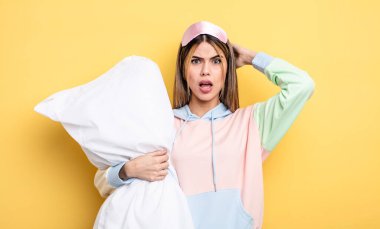 pretty woman feeling stressed, anxious or scared, with hands on head. pajamas concept