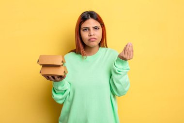 İspanyol kadın kapiş ya da para hareketi yapıyor, sana ödemeni söylüyor. Hamburger konseptini kaldır.