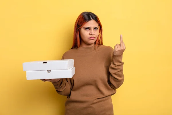 stock image hispanic woman feeling angry, annoyed, rebellious and aggressive. take away pizzas concept