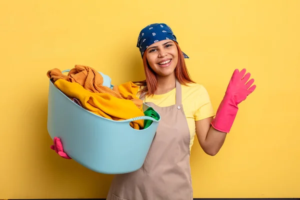 Housekeeper Smiling Happily Waving Hand Welcoming Greeting You Washing Clothes — Stock Photo, Image