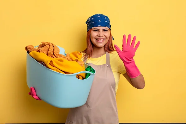 Housekeeper Smiling Looking Friendly Showing Number Five Washing Clothes Concept — Stock Photo, Image