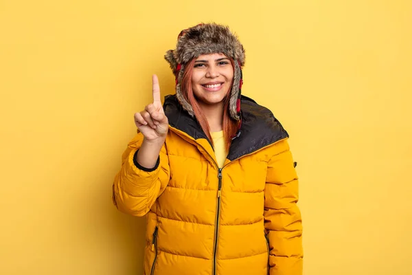 Hispanic Woman Smiling Looking Friendly Showing Number One Winter Concept — Stock Photo, Image