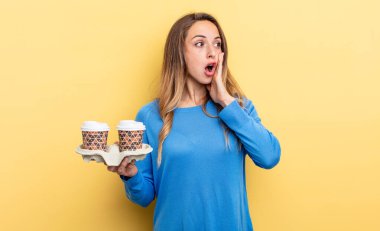 pretty woman feeling happy, excited and surprised. take away coffee concept