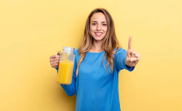 Pretty Woman Smiling Looking Friendly Showing Number One Orange Juice — Zdjęcie stockowe